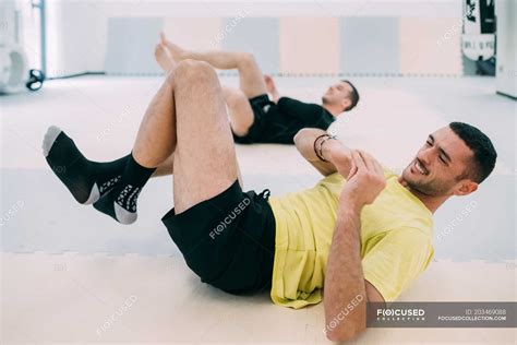 Man doing sit ups in gym — daylight, strength - Stock Photo | #203469088
