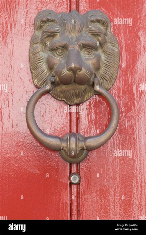 Wooden front door with lion door knocker hi-res stock photography and images - Alamy
