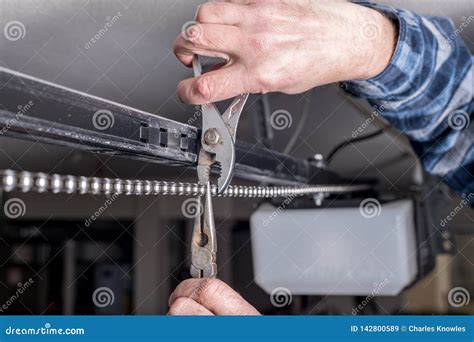 Home Garage Door Opener Chain Being Repaired by a Mechanic Stock Image - Image of repair, chain ...