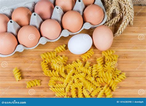 Uncooked Spiral Egg Pasta Different Sizes and Eggs Stock Photo - Image of helix, bamboo: 141638398