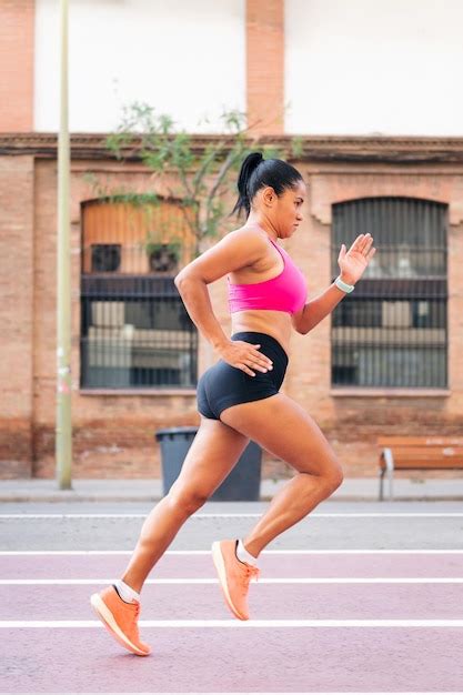 Premium Photo | Female athlete running during her training at city