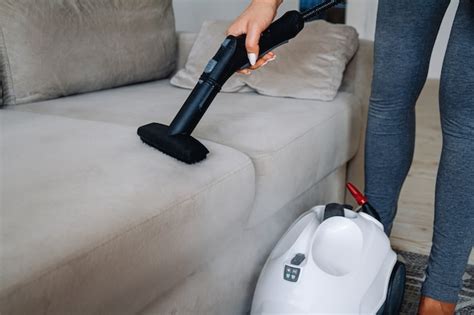 Premium Photo | Hand cleaning a sofa with a steam cleaner