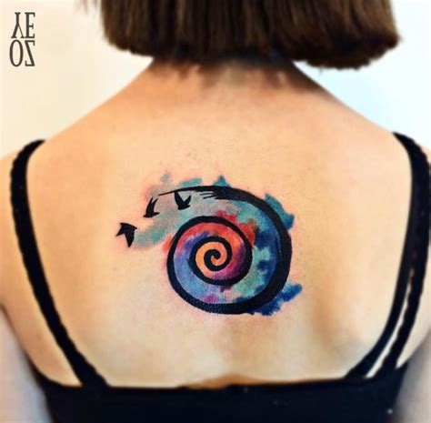 Ocean Waves Spiral Seashell Watercolor Tattoo On Arm | Spiral tattoos, Seashell tattoos, Rainbow ...