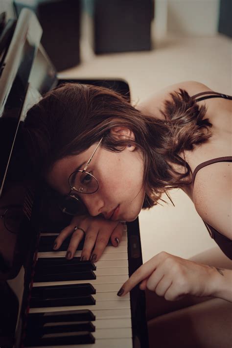 Woman Leaning on Piano Keys · Free Stock Photo