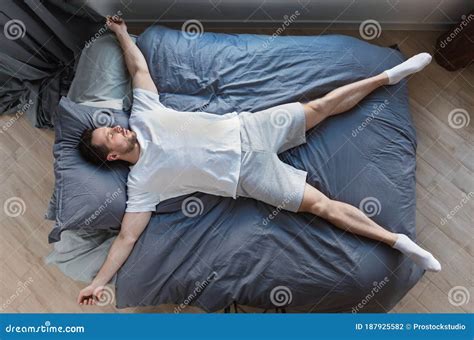 Man Sleeping Lying on Back in Bed at Home, Top-View Stock Photo - Image ...