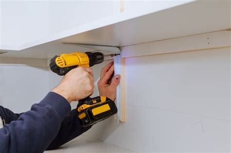 Premium Photo | Man installing wooden shelves on brackets wall installing a shelf