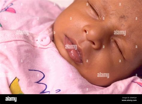 Extreme Close up face of a cute sleeping newborn baby. Closeup portrait ...