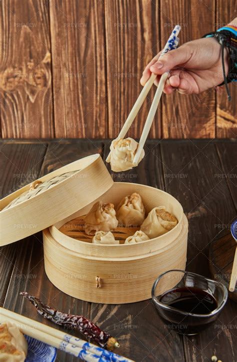 Chopsticks Holding Dumplings - Stock Photos | Motion Array