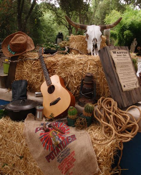 Western Theme must haves: Guitar, cowboy hats, rope, sacks, hay bales, wanted signs, lanterns ...