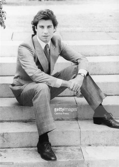 Portrait of actor John Travolta wearing a suit and tie and sitting on... | Actor john, John ...