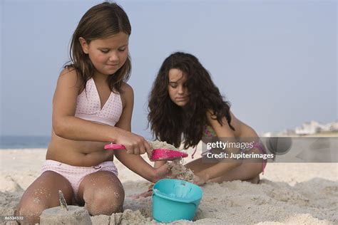 Girls Playing In Sand On Beach High-Res Stock Photo - Getty Images