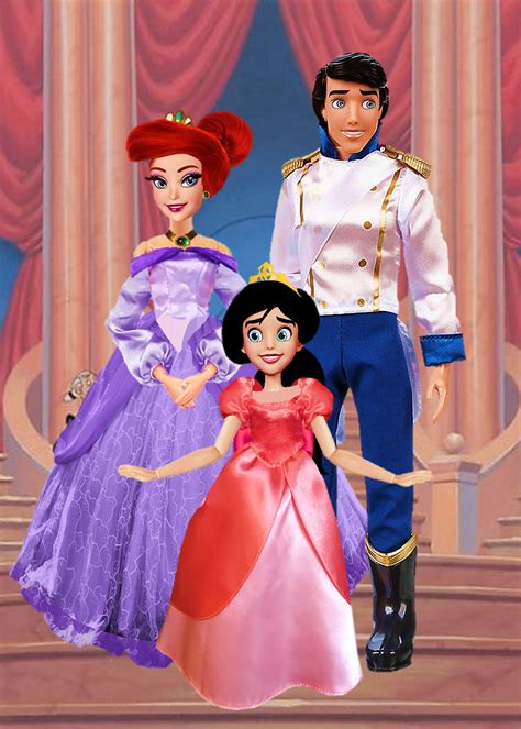 disney princess and prince doll standing next to each other in front of a stage with red curtains