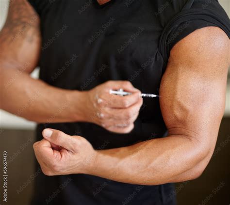 Arm, steroids and syringe with a bodybuilder man using a needle for a bicep muscle injection ...