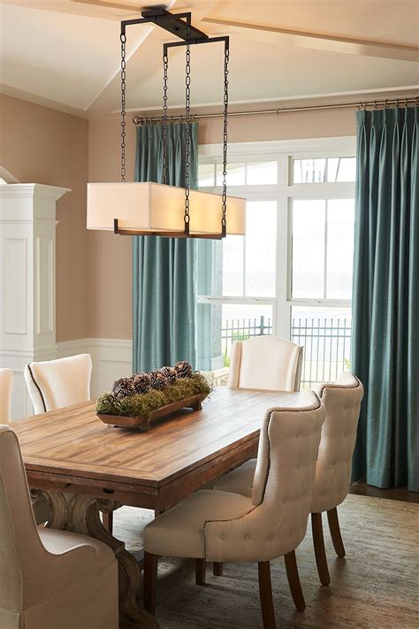 If you have a long dining room table, try using a linear chandelier to light it. Look for ones ...