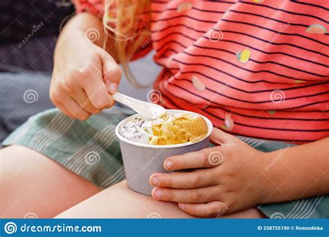 Little Adorable Preschool Girl Eating Ice Cream Sundae in Cup on Sunny Summer Day. Happy Toddler ...