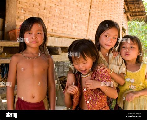 Lao girls in front of their home in Muang Ngoi village in northern Laos ...