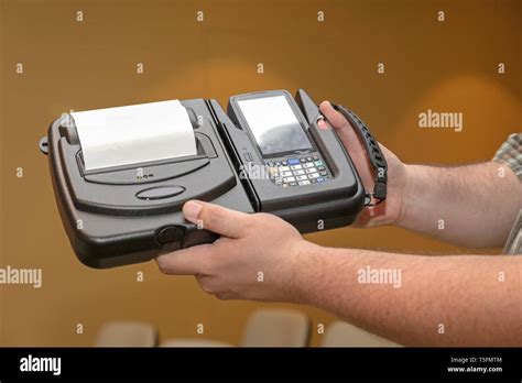 Man Holding Portable Barcode Printer and Reader Computer Device Stock Photo - Alamy