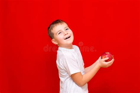 Side View Smiling Caucasian Boy Kid Child Schoolboy Holds a Red Apple in His Hands. Vitamins and ...