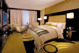 This gold and black hotel room with a king size bed is perfect for wedding guests. | OneWed.com