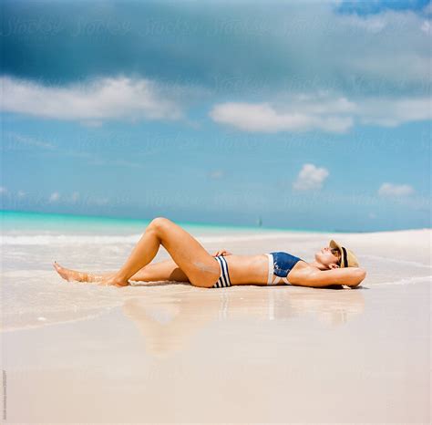 Beautiful Woman In A Bikini Laying On A Beach | Stocksy United