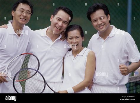 Portrait of a group of people at a tennis court Stock Photo - Alamy