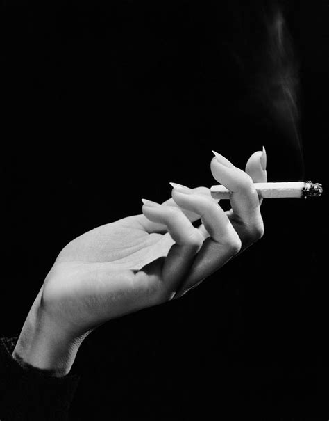 Woman's Hand Holding Lit Cigarette Photograph by George Marks