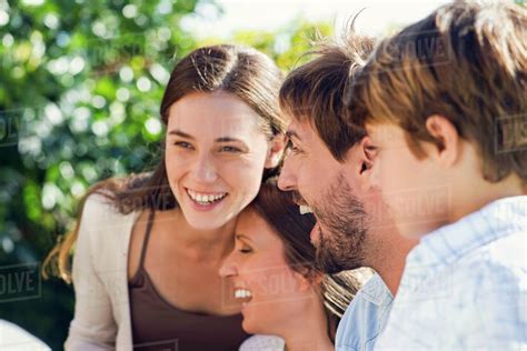 Family laughing together outdoors - Stock Photo - Dissolve