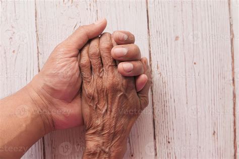 Old person and young person holding hands 2060090 Stock Photo at Vecteezy