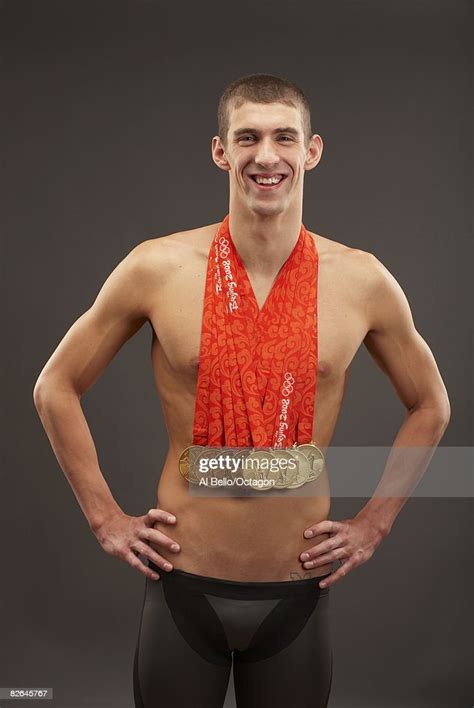 Swimmer Michael Phelps of the United States poses with his eight gold... News Photo - Getty Images