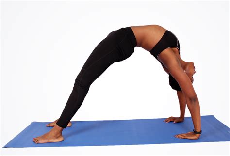 Flexible Man Doing Yoga Back Bridge Pose on Blue Yoga Mat