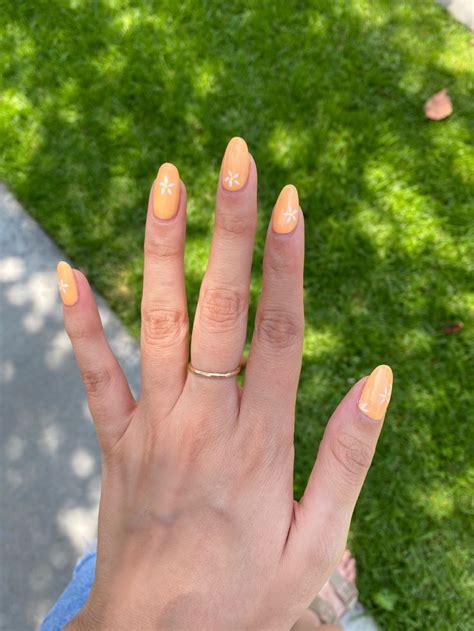 gel nails with chamomile flowers 💫 | Beige nails design, Beige nails, Orange nails