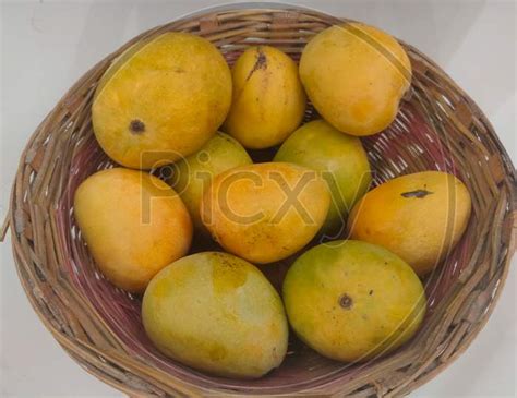 Image of Mango Fruit In Wooden Basket Putting On Ceramic Floor Tile ...