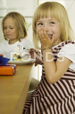 Two girls (4-5) eating cake in kitchen Stock Photos #AD ,#cake#eating#girls#Photos | Two girls ...