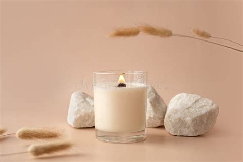 Vanilla Burning Candle on Beige Background. Aesthetic Composition with Stones and Dry Flowers ...