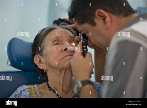 GUATEMALA SAN PEDRO LA LAGUNA Volunteer Guatemalan eye doctor examines the eyes of an elderly ...
