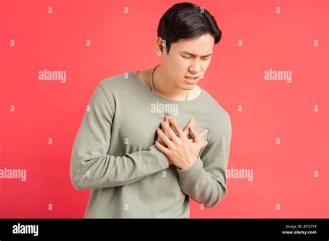 A photo of a handsome Asian man holding his arms around his chest ...