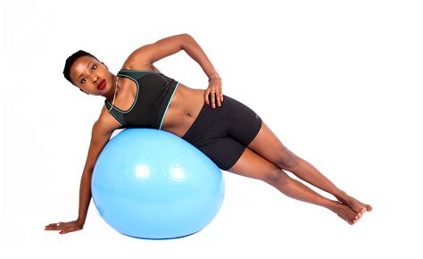 Fit Woman Lying on Swiss Ball Doing Side Plank - High Quality Free ...