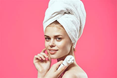 Premium Photo | Woman with a towel on her head massagers in hands clean skin health care