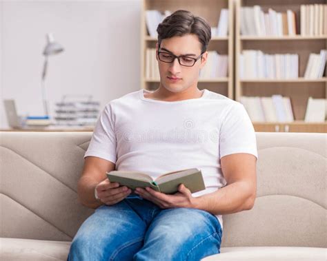 Man Reading Book Sitting in Couch Sofa Stock Photo - Image of house ...