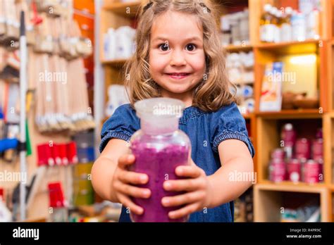 Child with color or paint pigments in store Stock Photo - Alamy