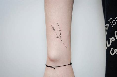 Fine line Taurus constellation tattoo on the wrist