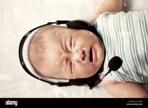 A baby wearing a headset Stock Photo - Alamy