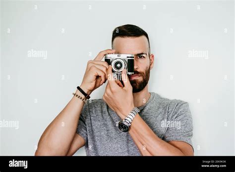 Young man holding vintage camera Stock Photo - Alamy