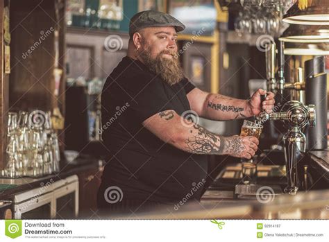 Tattooed Man Standing at Bar Counter Stock Image - Image of pour, client: 92914187