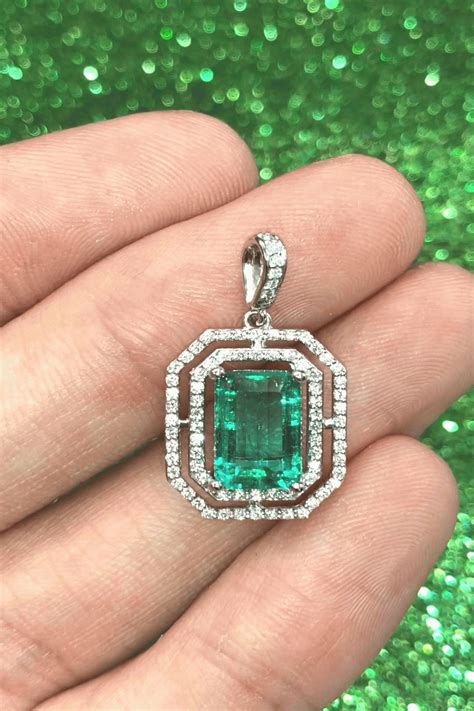 350 Carat Elongated Colombian Emerald and diamond platinum halo pendant A stunning vivid rich gr ...