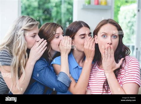 Women in a row whispering secrets in their friends ears Stock Photo - Alamy