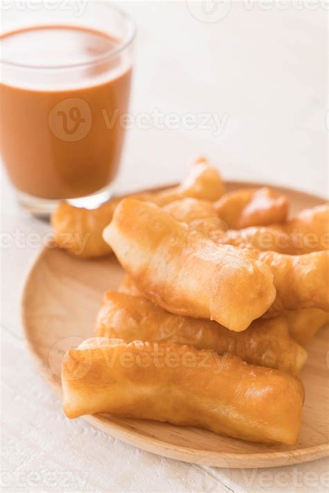 Deep-fried dough stick with milk tea on wood 3109016 Stock Photo at Vecteezy