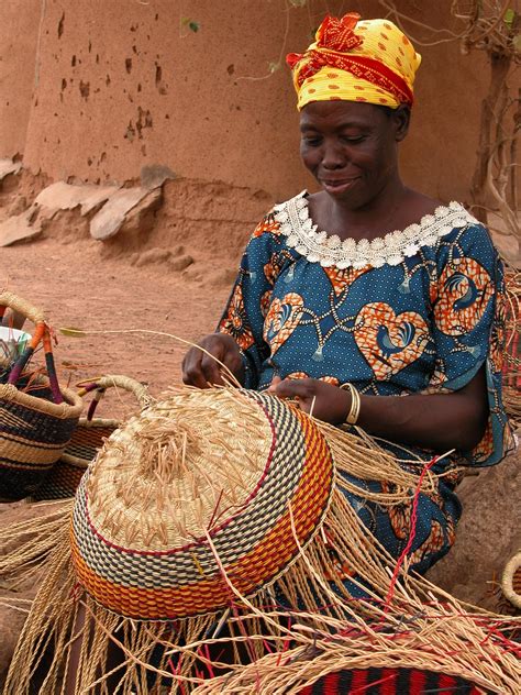 This picture shows a woman weaving a traditional African basket. Basket ...