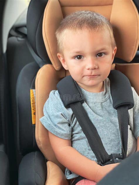 Caucasian Child on a Black Car Seat with a Peach Center. Stock Photo - Image of road, rental ...