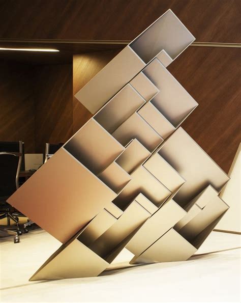 an abstract piece of art in the middle of a room with chairs and desks